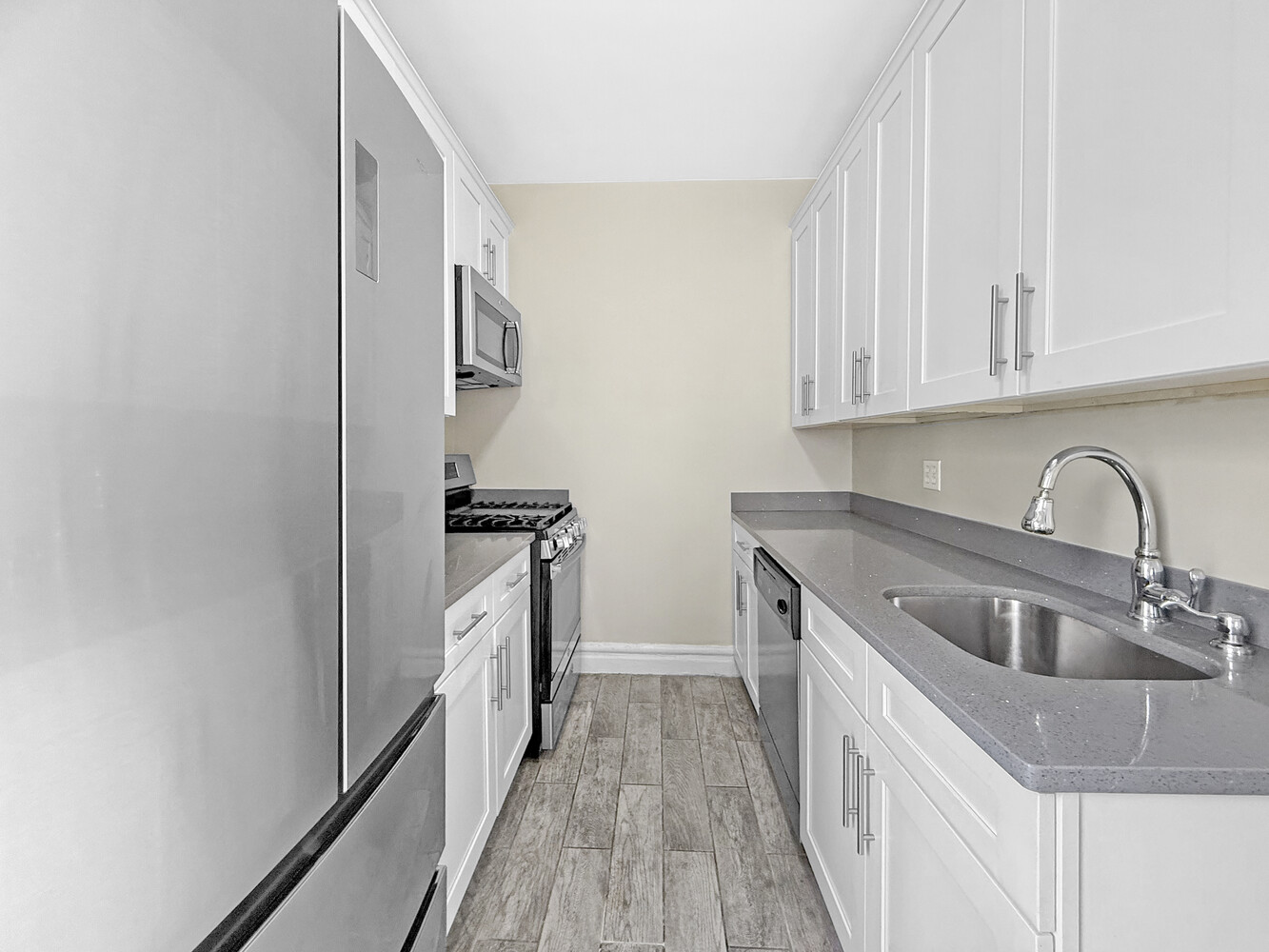 80 Winthrop Street, Unit L5 Brooklyn, NY 11225 - Photo 4 of 19 a kitchen with stainless steel appliances granite countertop a sink stove and refrigerator