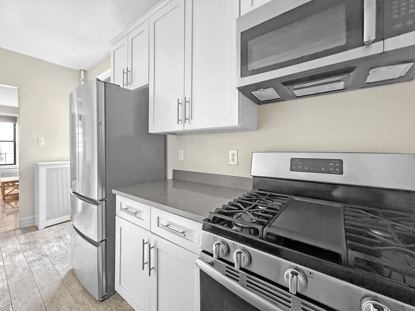80 Winthrop Street, Unit L5 Brooklyn, NY 11225 - Photo 5 of 19 a kitchen with stainless steel appliances granite countertop a refrigerator and a stove