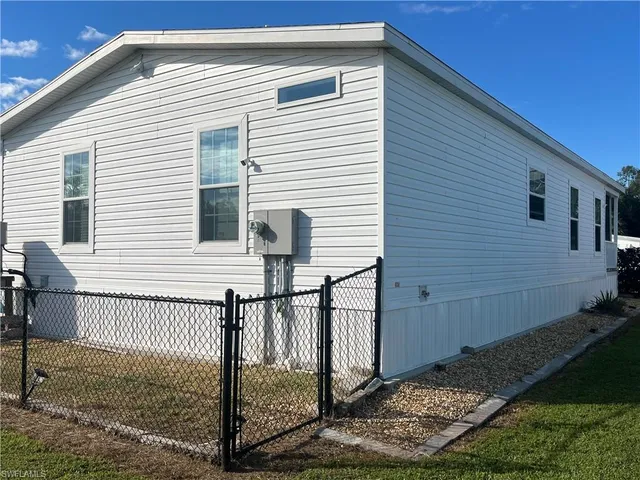a front view of a house with wooden fence