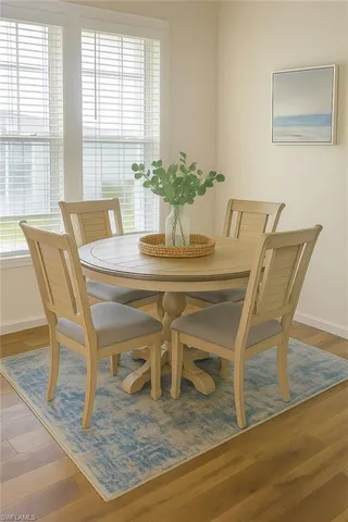 a view of a dining room with furniture and wooden floor