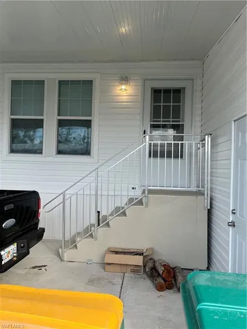 a view of a livingroom with furniture and staircase