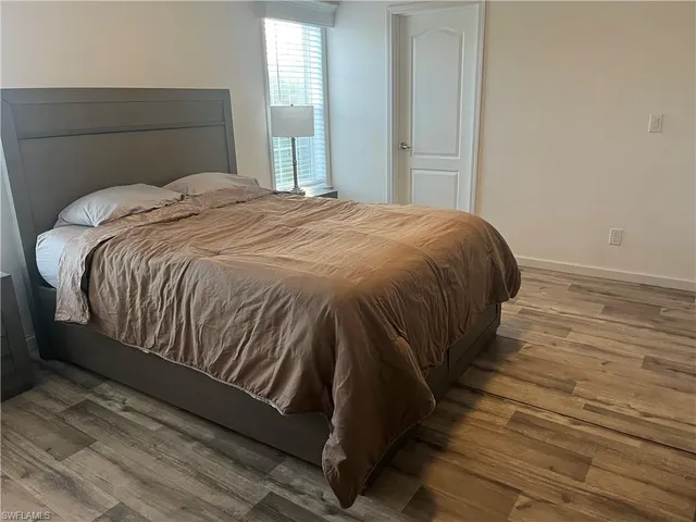 a bed sitting in a bedroom next to a window