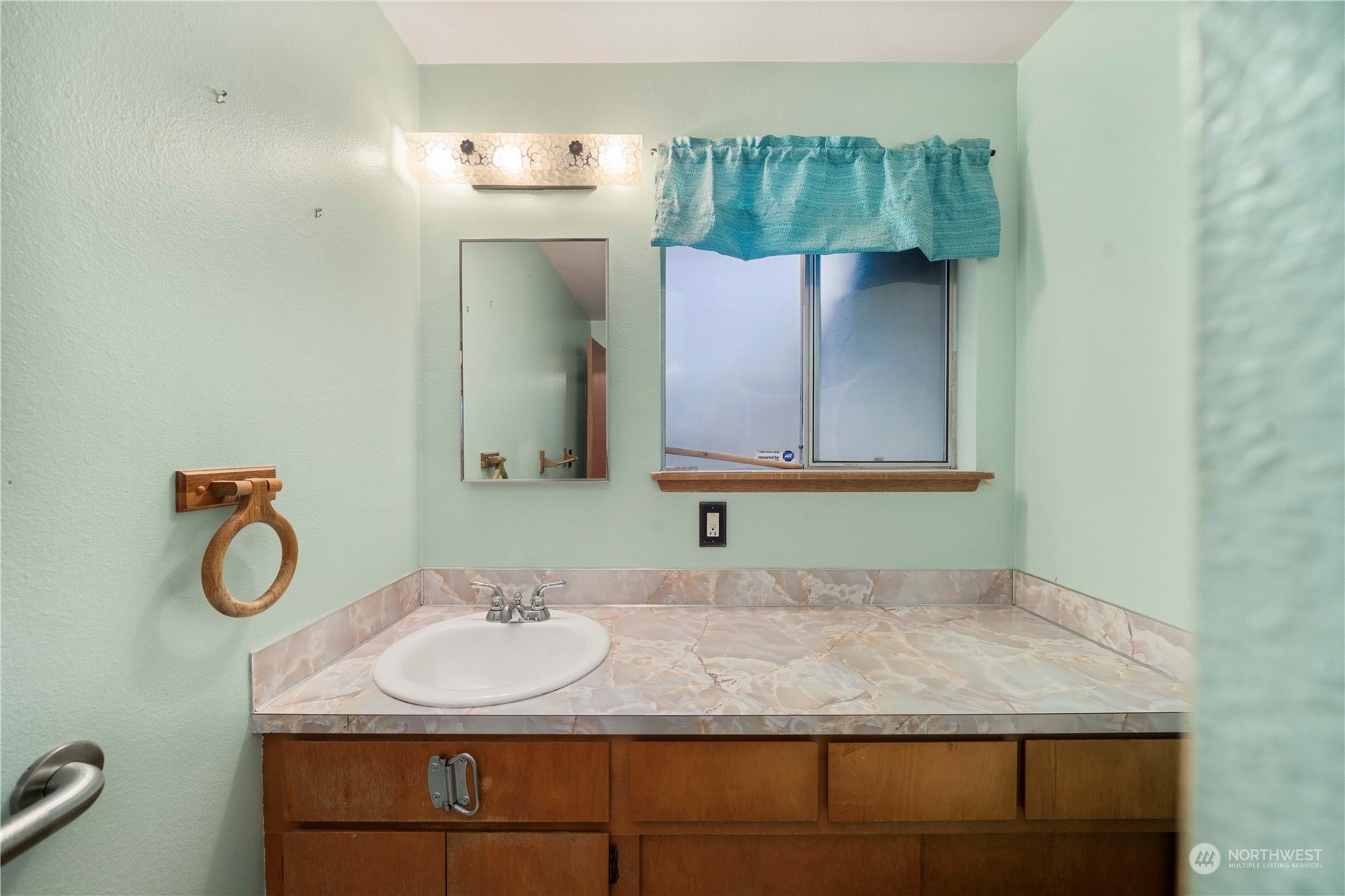 903 Southwest 104th Street Seattle, WA 98146 - Photo 16 of 26 a bathroom with a sink and a mirror