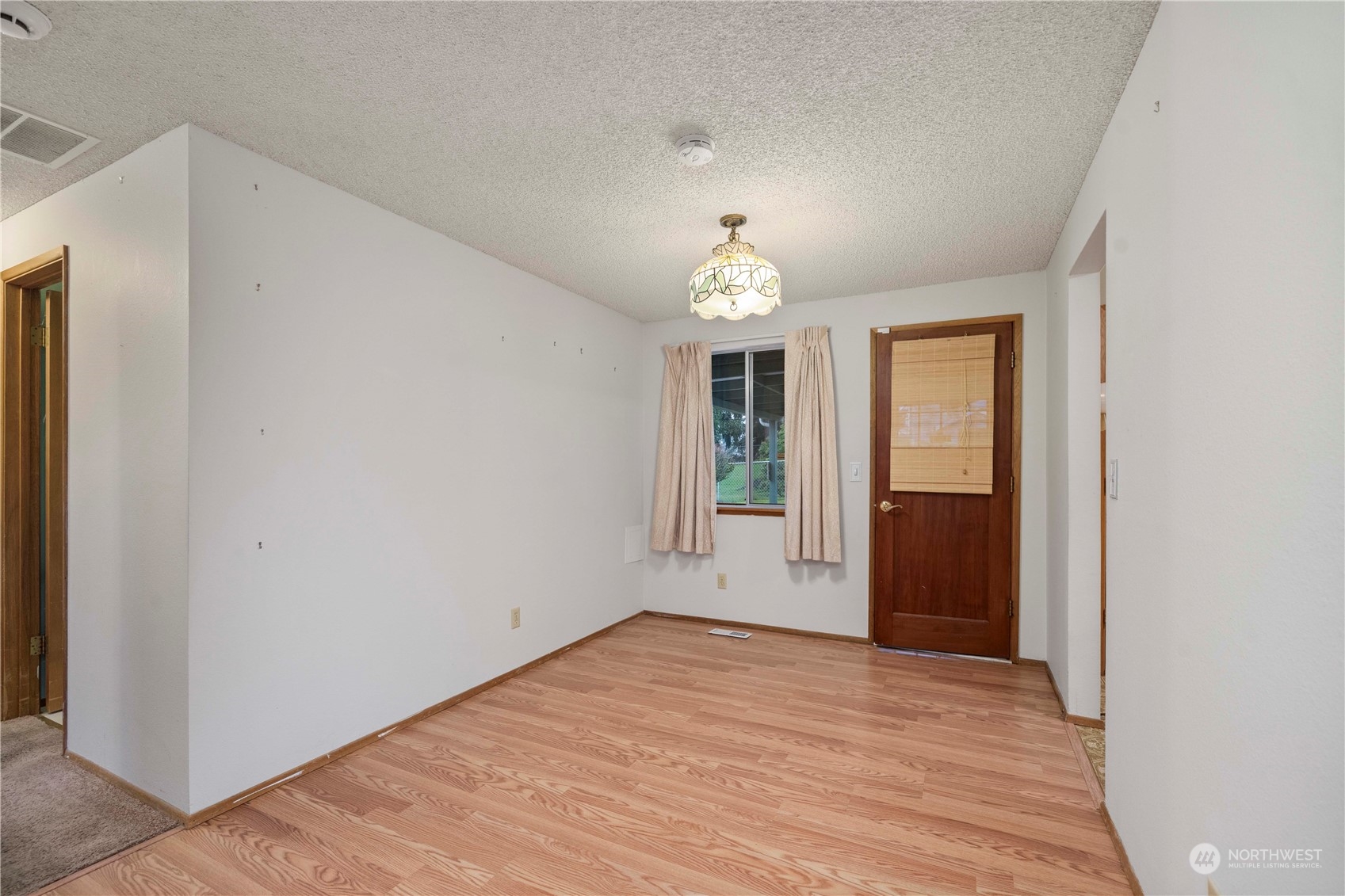 903 Southwest 104th Street Seattle, WA 98146 - Photo 5 of 26 a view of empty room with wooden floor