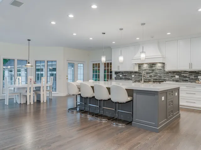 a kitchen with a sink and white cabinets