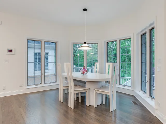 a dining room with furniture a chandelier and wooden floor