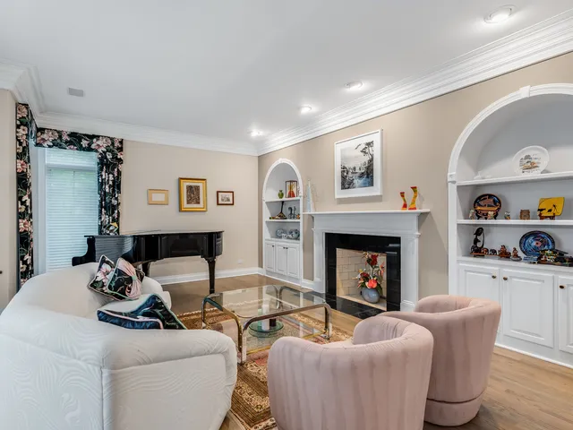 a spacious bedroom with a large bed and a chandelier
