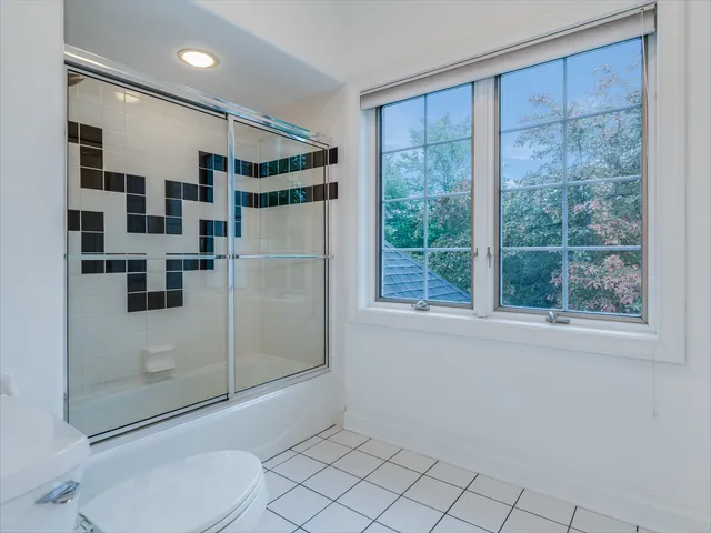 a bathroom with a double vanity sink mirror and toilet