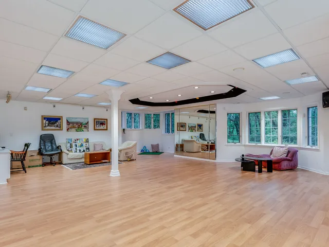 an aerial view of residential house with outdoor space and trees all around