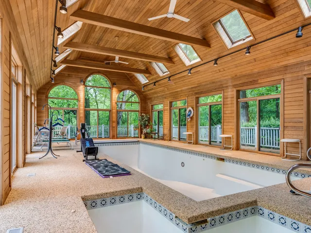 an aerial view of a house with swimming pool and garden