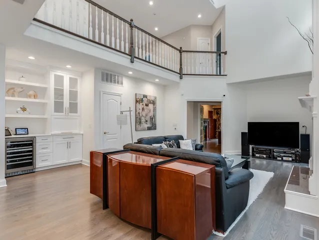 a living room with furniture a flat screen tv and kitchen view
