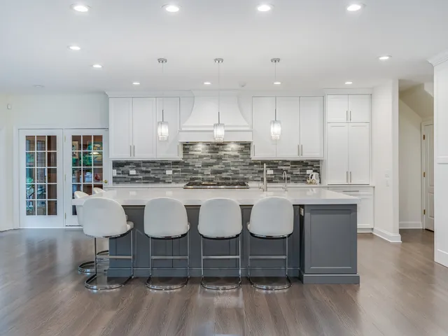 a kitchen with kitchen island granite countertop a sink and cabinets