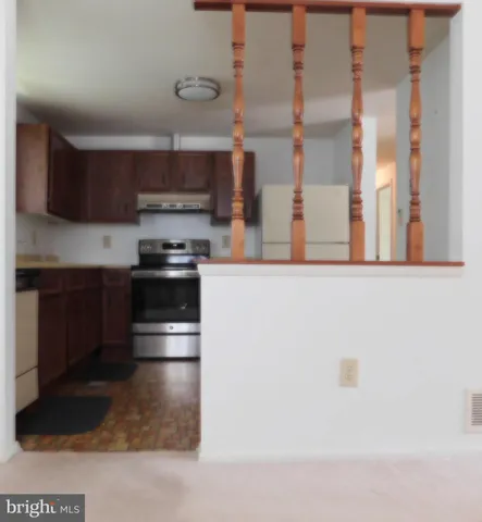 a kitchen with stainless steel appliances granite countertop a stove and a refrigerator