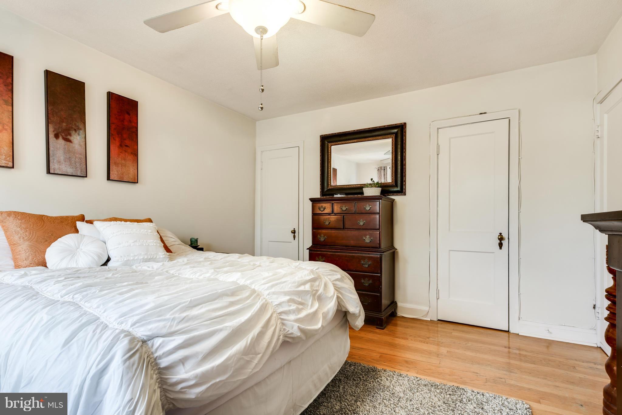 431 Academy Road Catonsville, MD 21228 - Photo 14 of 30 a bedroom with a bed and a chandelier