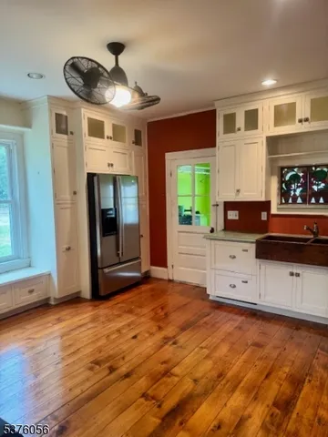 a view of a kitchen with stainless steel appliances granite countertop a stove and a refrigerator