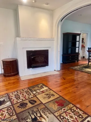a living room with a fireplace and a rug