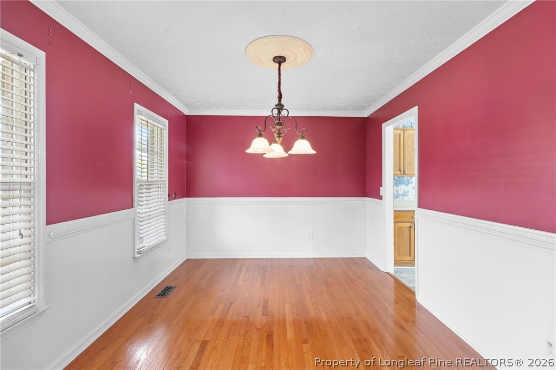 28 Coyt Circle Spring Lake, NC 28390 - Photo 10 of 41 a view of a room with wooden floor and a chandelier