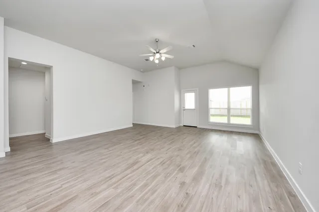 a view of a kitchen with furniture and wooden floor