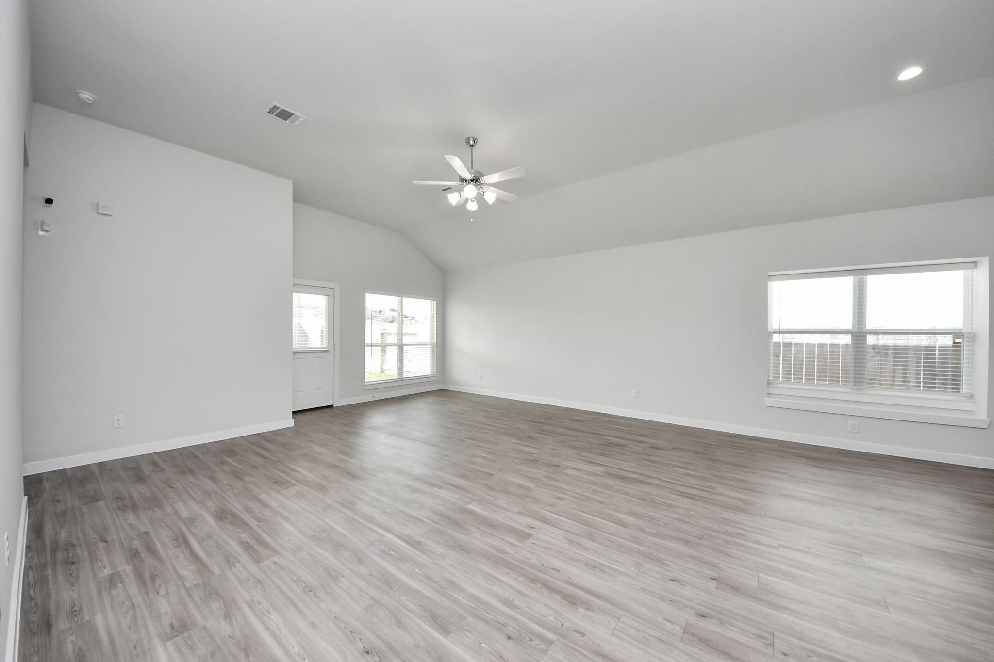21507 Indigo Ruth Drive Spring, TX 77379 - Photo 16 of 33 an empty room with wooden floor and windows