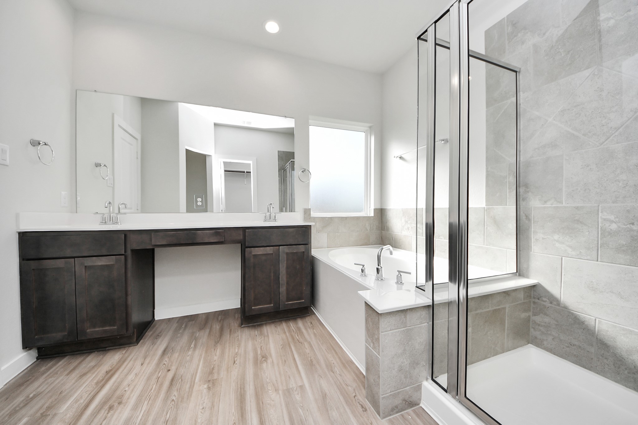 21507 Indigo Ruth Drive Spring, TX 77379 - Photo 22 of 33 a bathroom with a double vanity sink a mirror and a bathtub