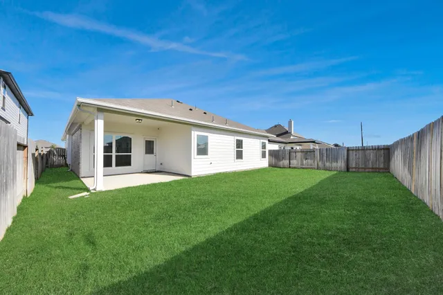 a view of a backyard with a garden and deck