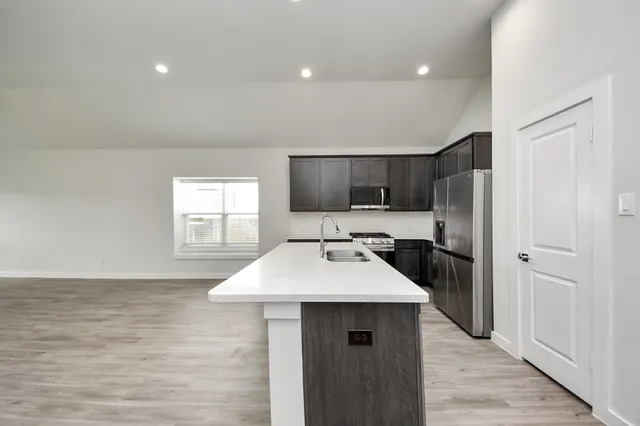 a kitchen with a sink and a refrigerator