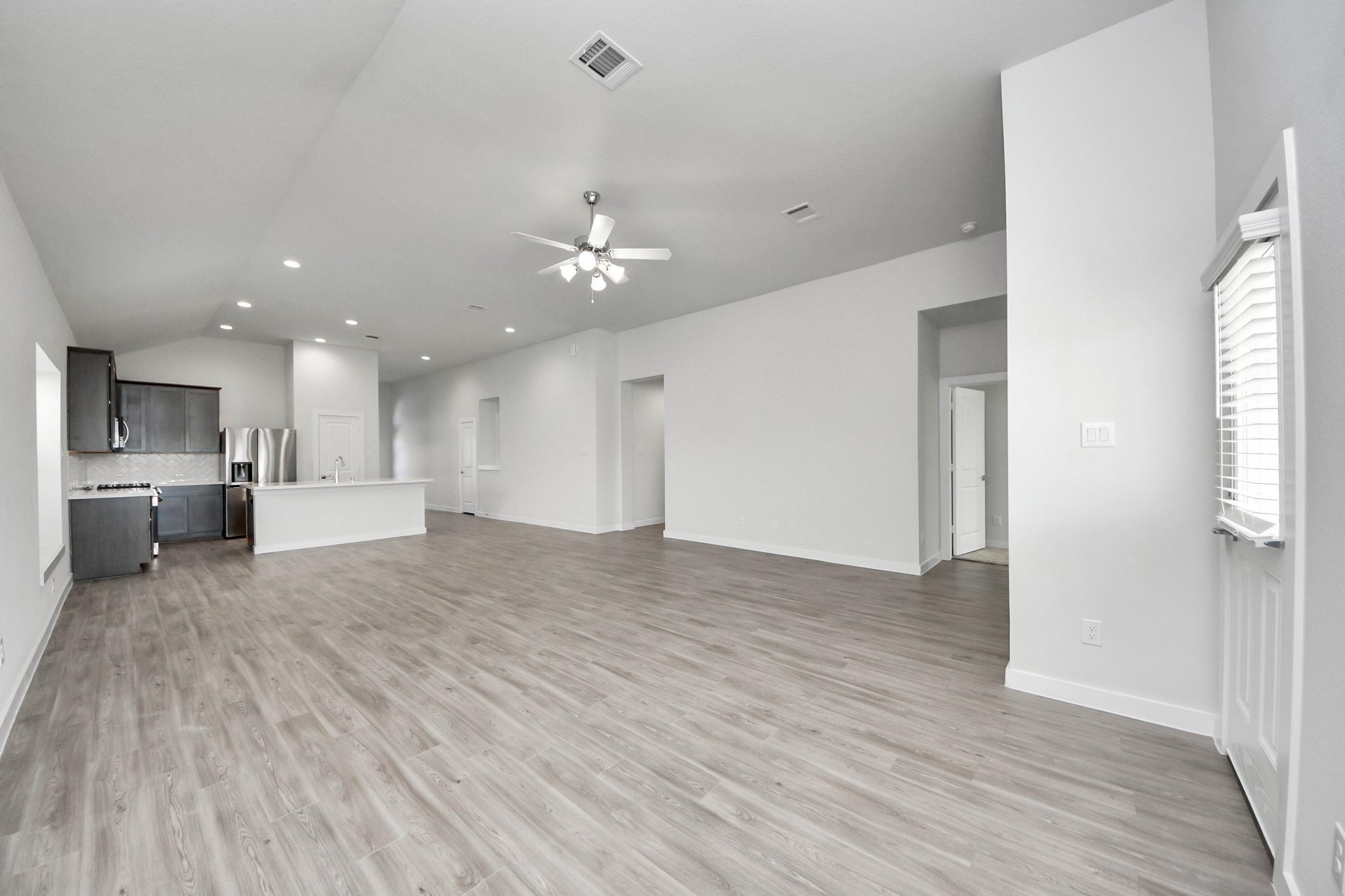 21507 Indigo Ruth Drive Spring, TX 77379 - Photo 9 of 33 a view of kitchen and empty room with wooden floor
