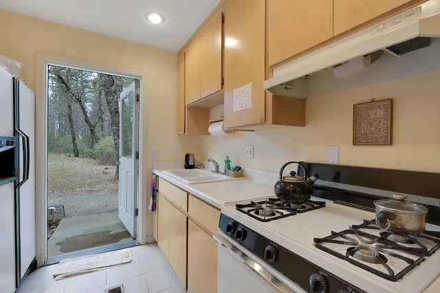 a kitchen with a stove and a refrigerator