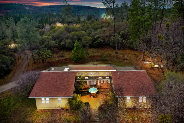an aerial view of a house with yard swimming pool and outdoor seating