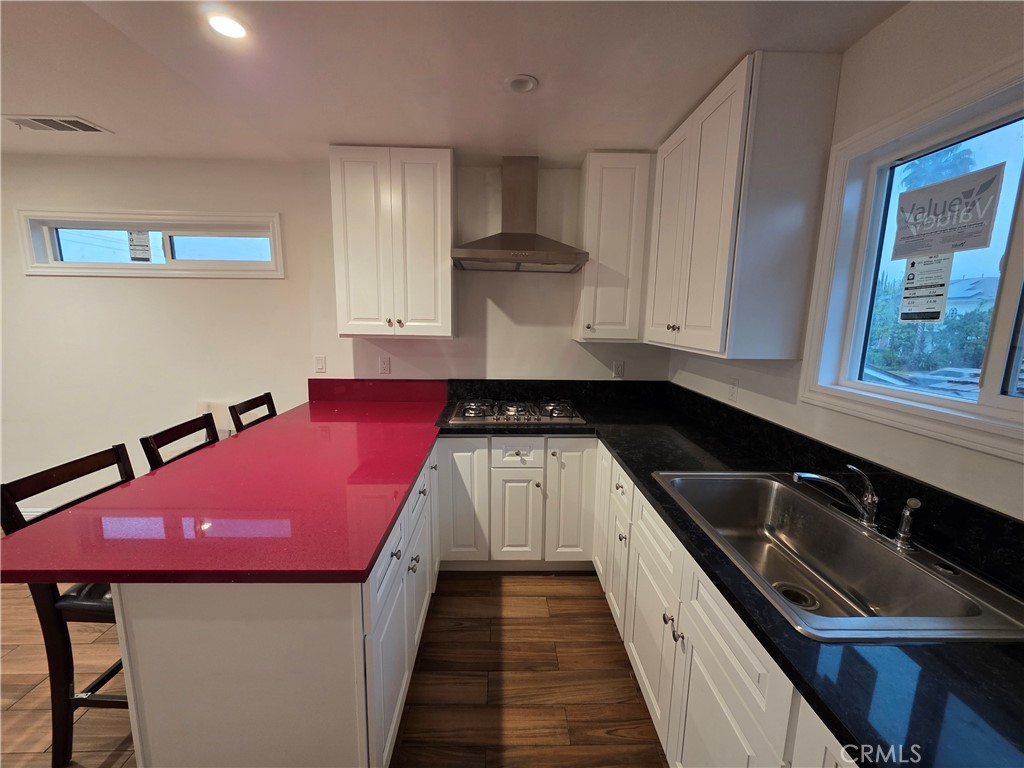 508 Sharon Road Arcadia, CA 91007 - Photo 8 of 10 a kitchen with a sink stove and cabinets