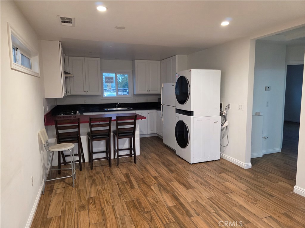 508 Sharon Road Arcadia, CA 91007 - Photo 9 of 10 a kitchen with wooden floors and wooden cabinets