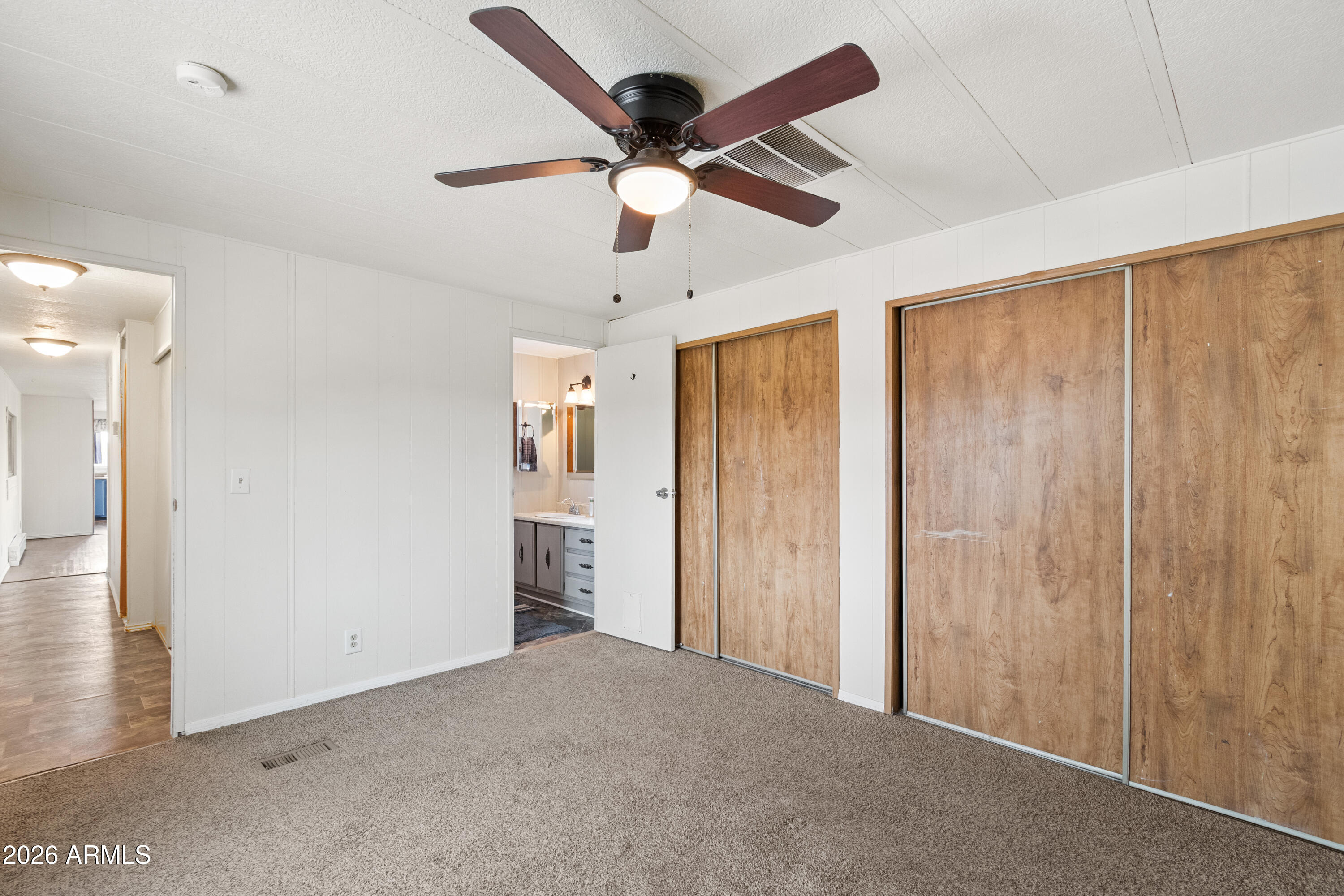 2385 County Line Circle Ash Fork, AZ 86320 - Photo 14 of 35 a view of an empty room and a ceiling fan