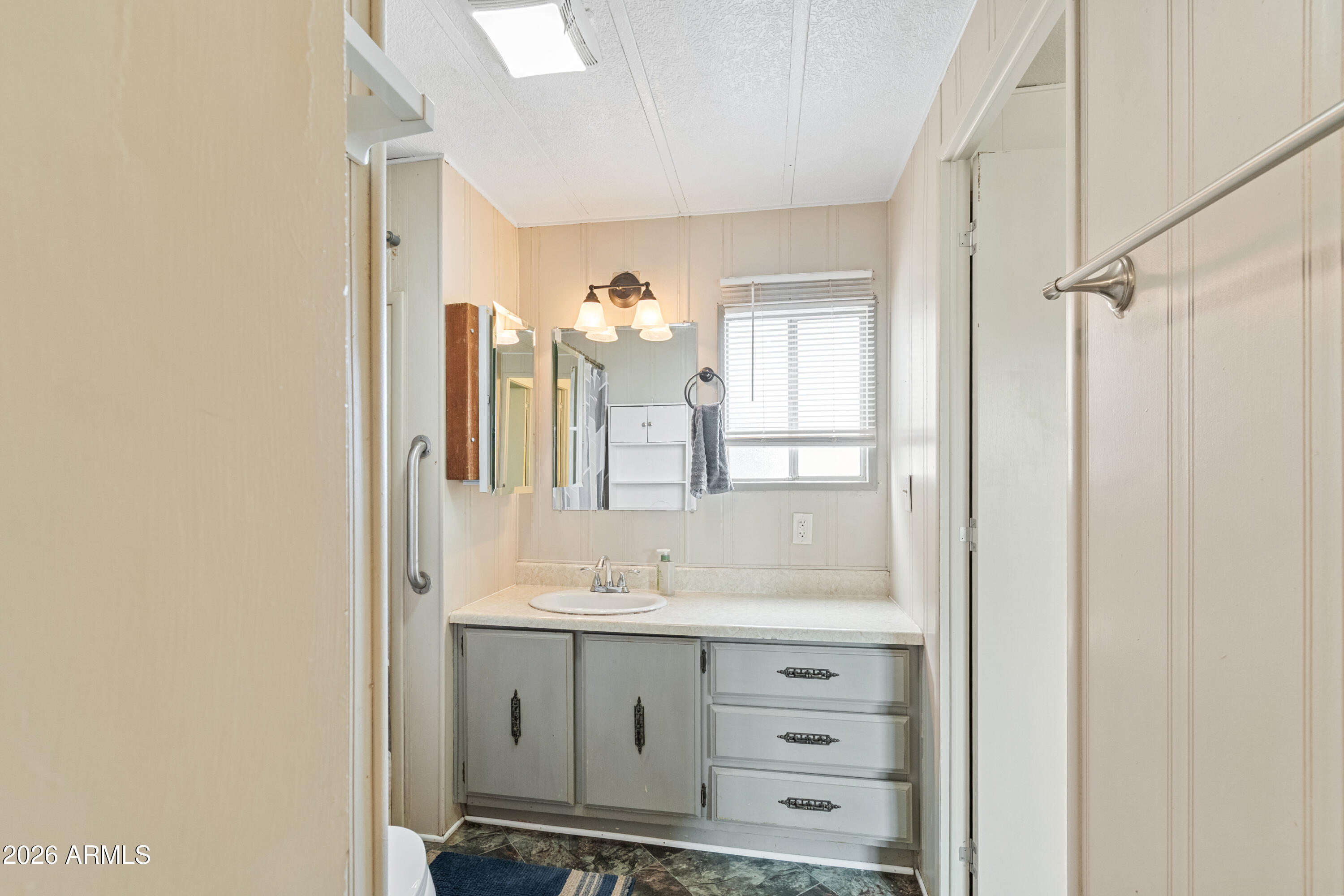 2385 County Line Circle Ash Fork, AZ 86320 - Photo 16 of 35 a bathroom with a sink vanity granite and a mirror