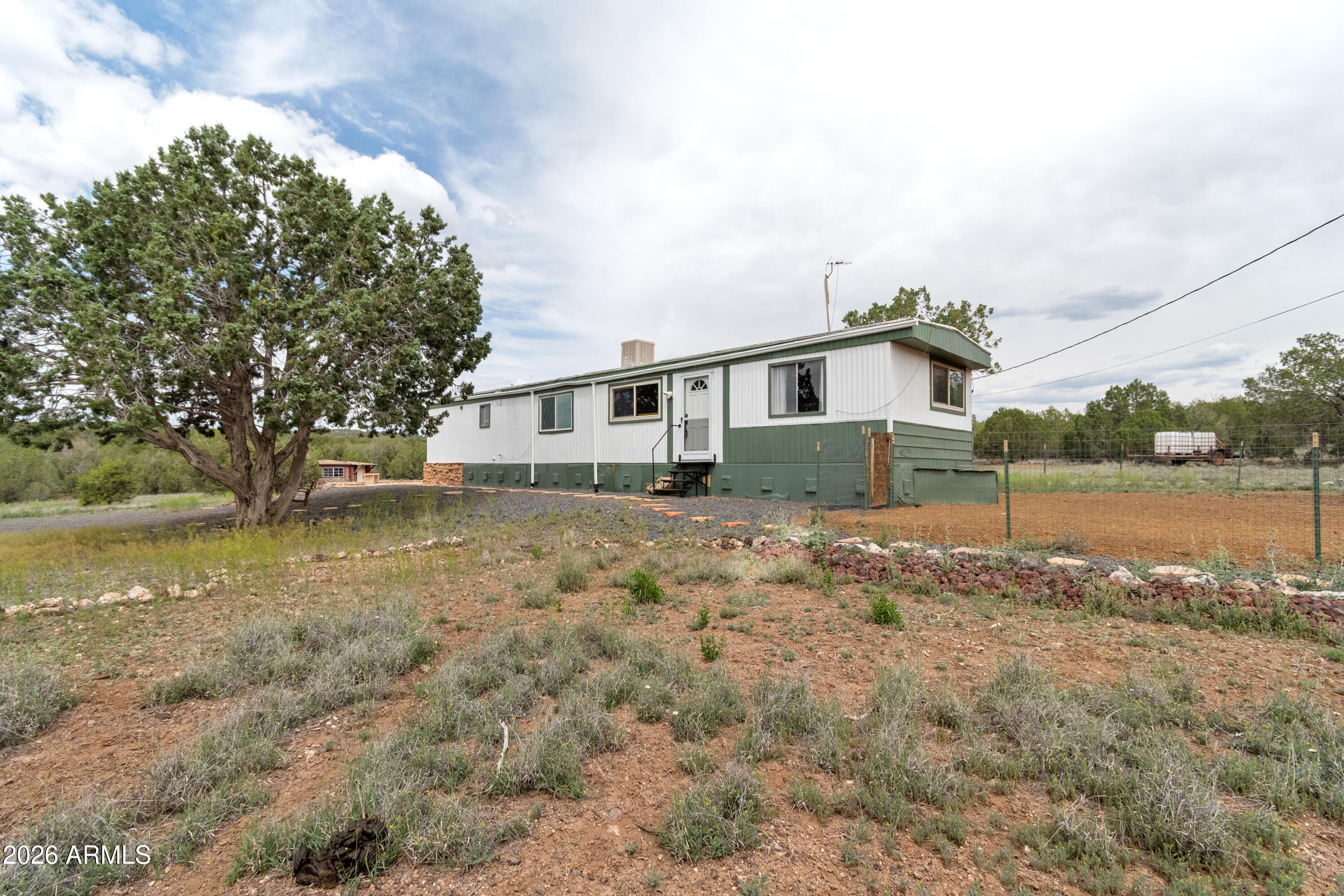 2385 County Line Circle Ash Fork, AZ 86320 - Photo 2 of 35 a view of a house with a yard