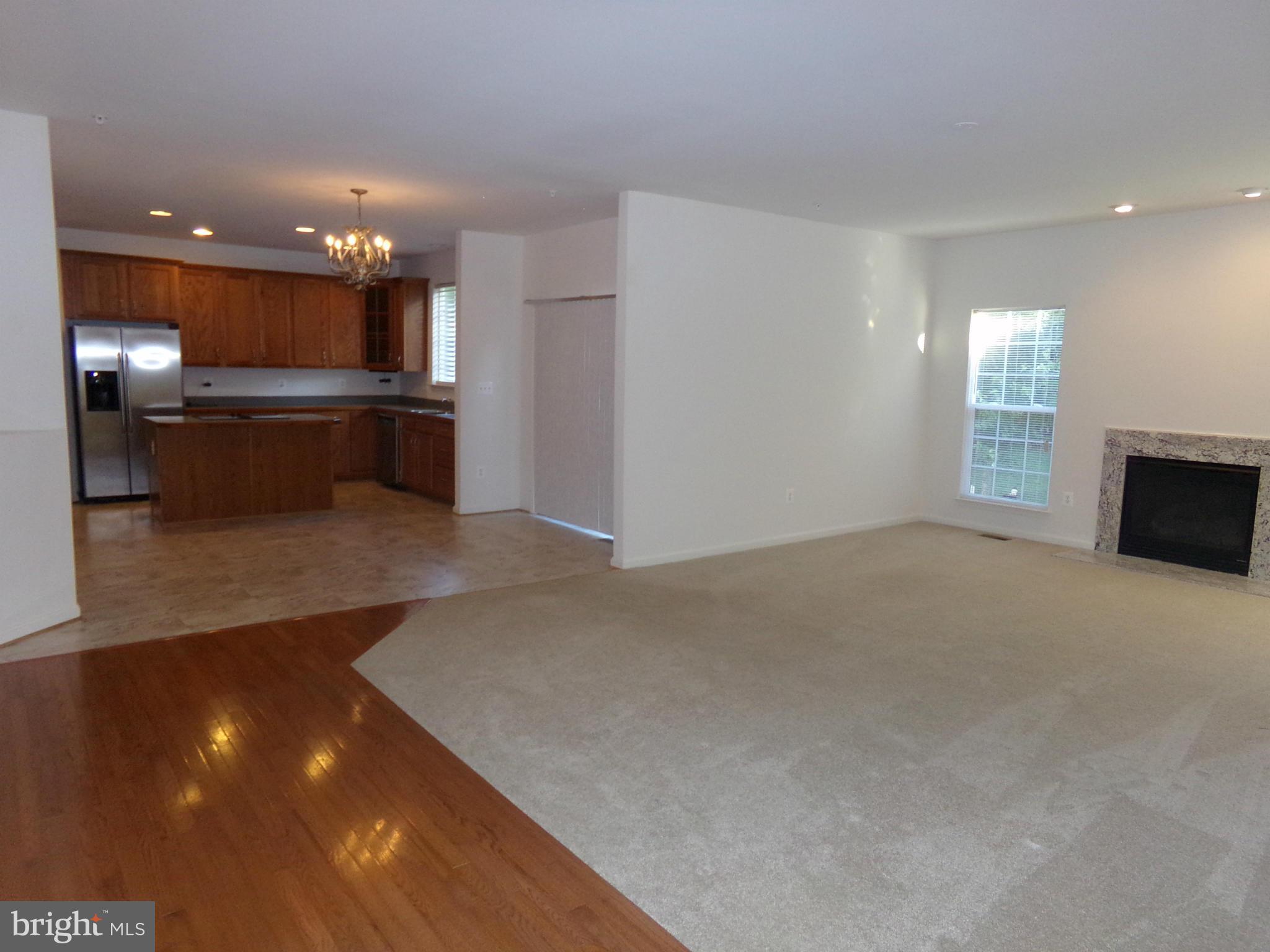9834 Farm Pond Road Laurel, MD 20708 - Photo 12 of 30 a view of kitchen with kitchen island a sink dishwasher a stove and a refrigerator with wooden floor