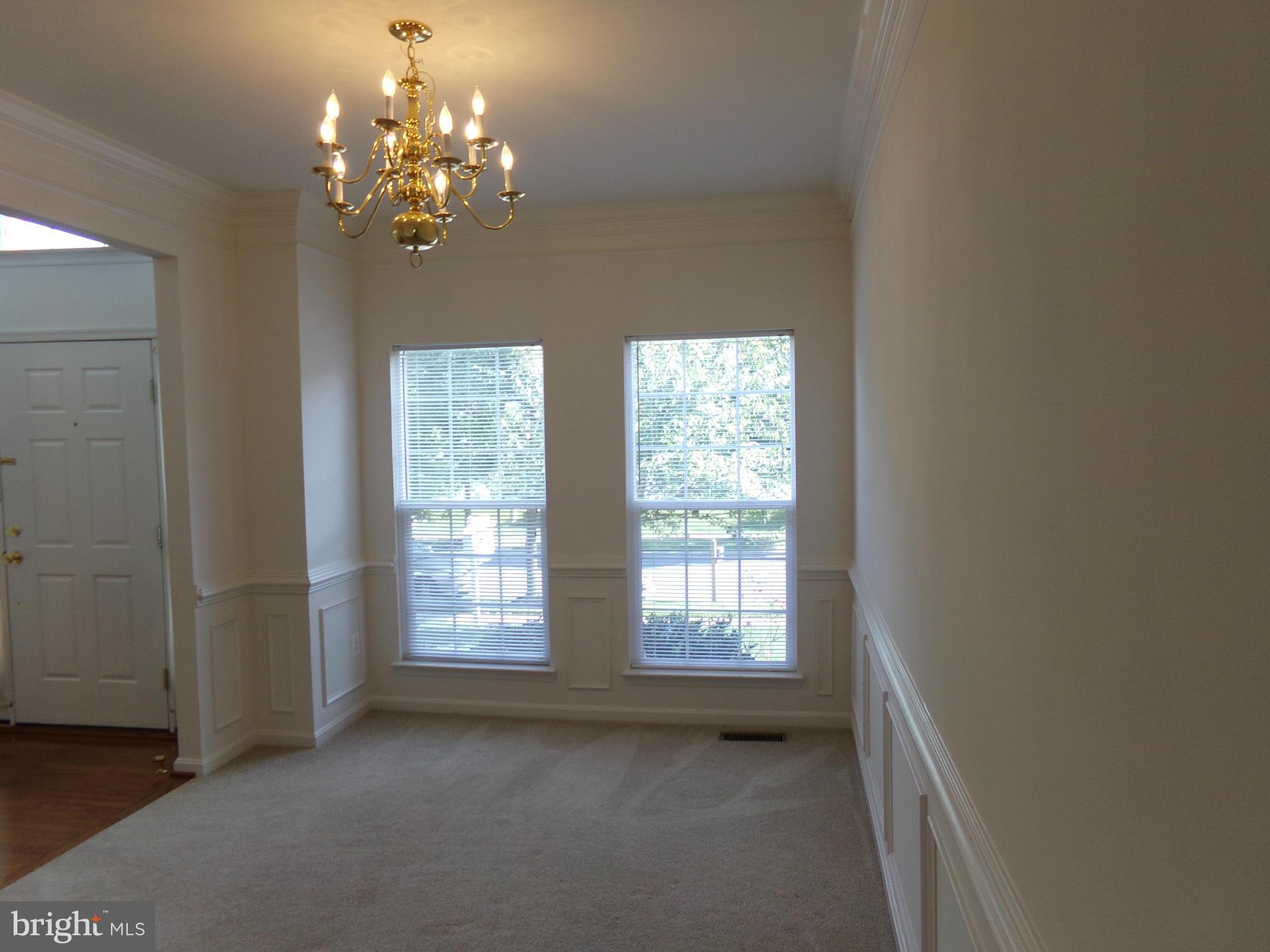9834 Farm Pond Road Laurel, MD 20708 - Photo 15 of 30 a view of a spacious bathroom with windows and chandelier