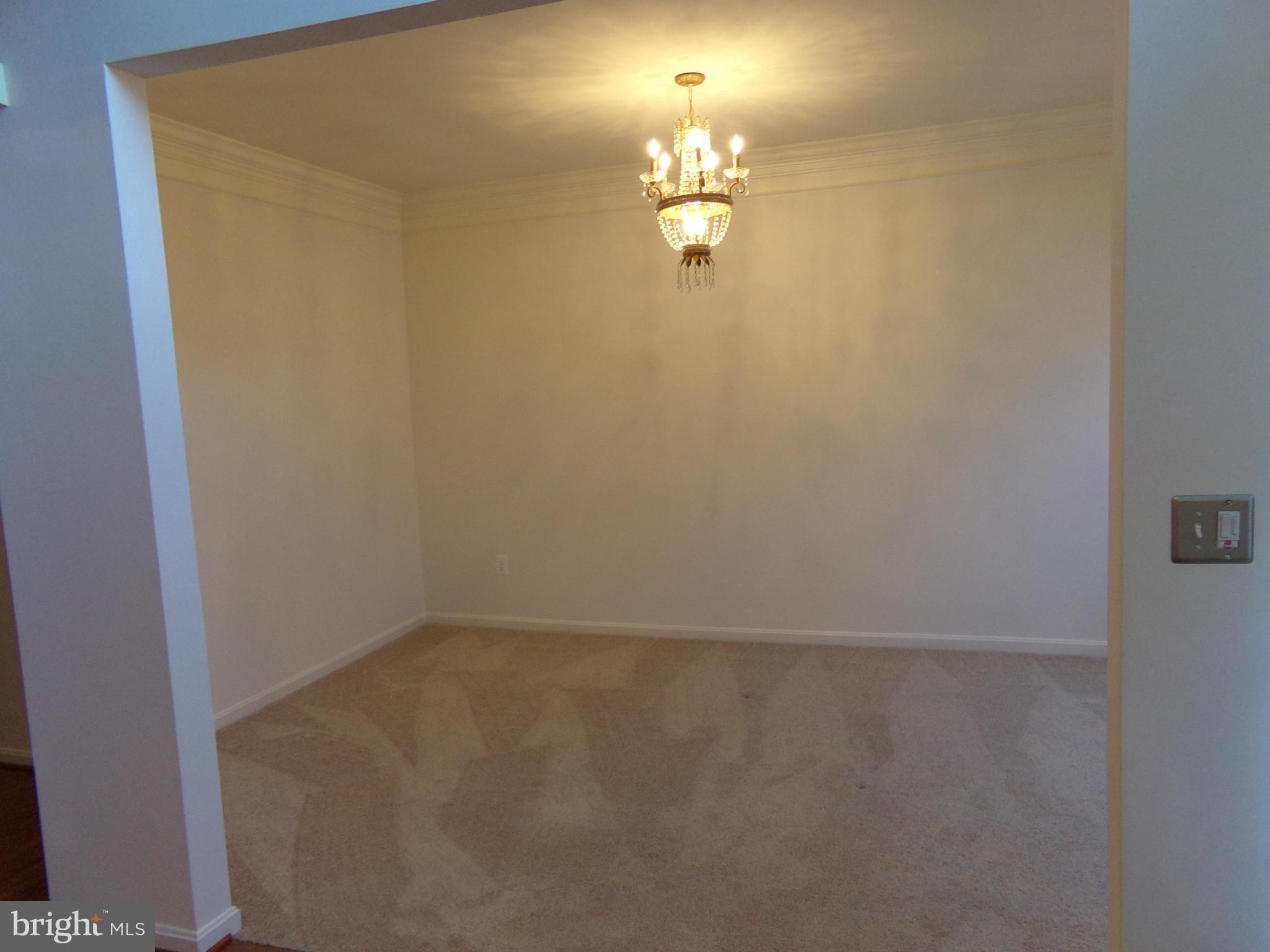 9834 Farm Pond Road Laurel, MD 20708 - Photo 17 of 30 a view of a room with a chandelier fan