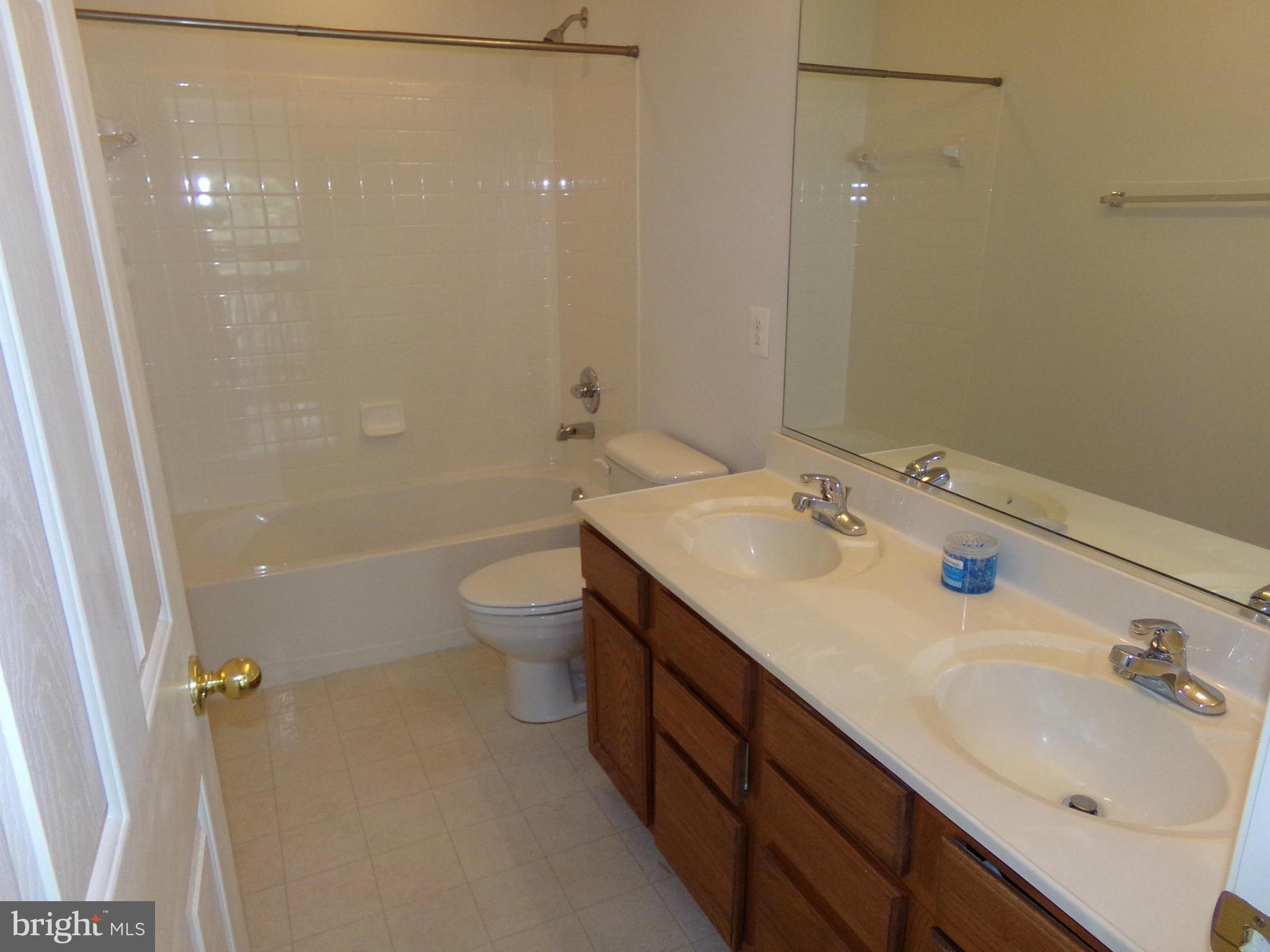 9834 Farm Pond Road Laurel, MD 20708 - Photo 26 of 30 a bathroom with a sink a toilet and shower
