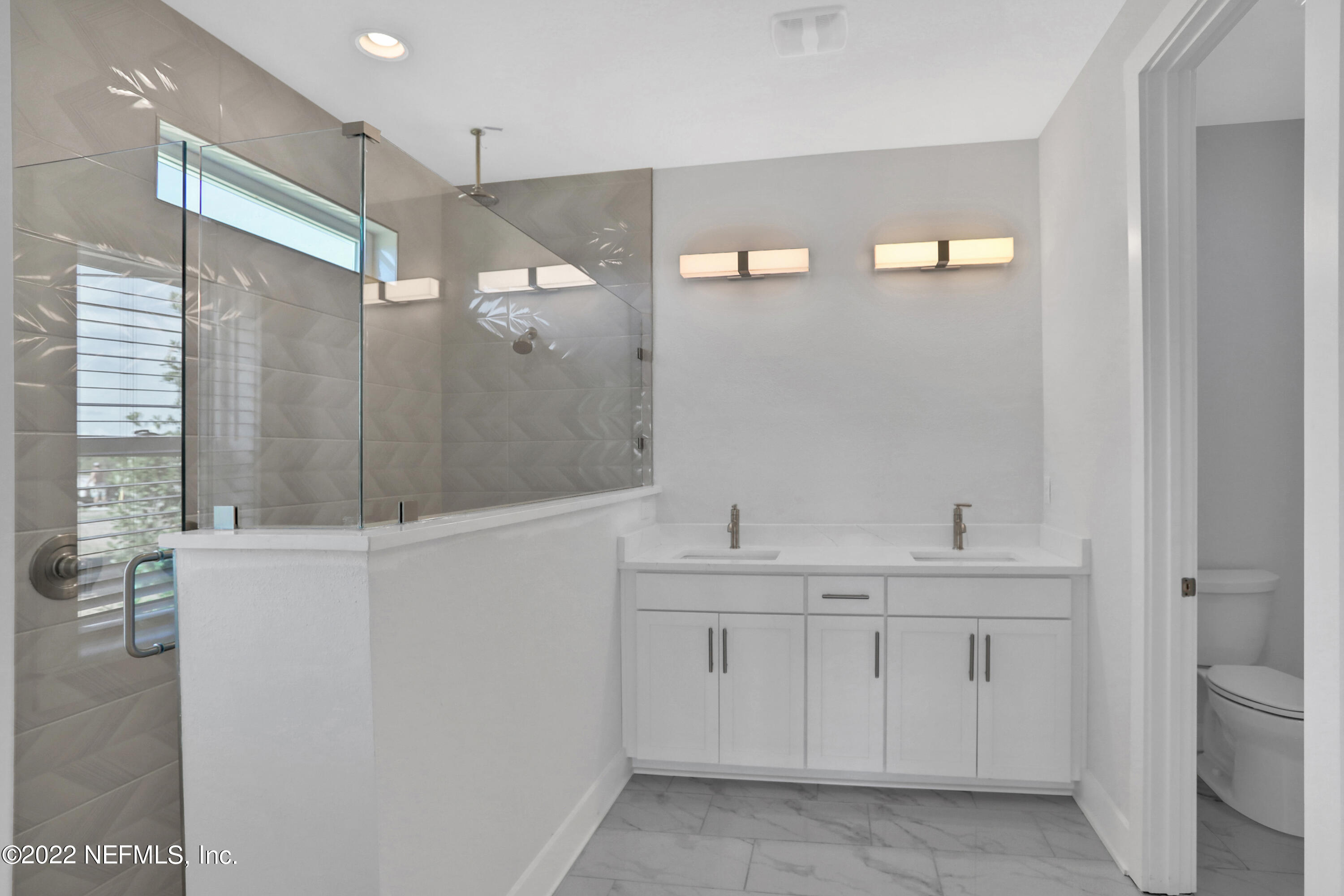 278 Farmfield Drive St. Augustine, FL 32092 - Photo 27 of 36 a spacious bathroom with a shower sink and mirror