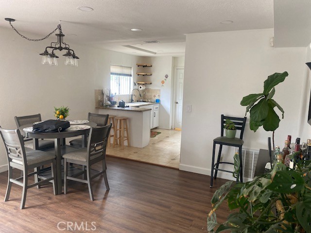 1665 North Fillmore Avenue Rialto, CA 92376 - Photo 3 of 23 a dining room with furniture potted plants and wooden floor