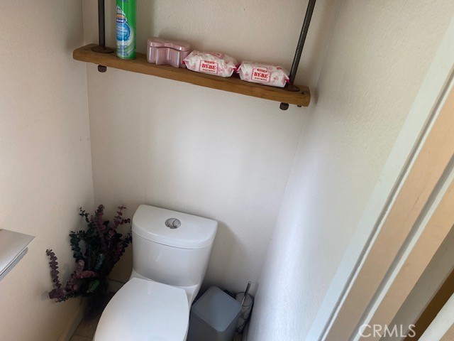 1665 North Fillmore Avenue Rialto, CA 92376 - Photo 6 of 23 a white toilet sitting next to a sink