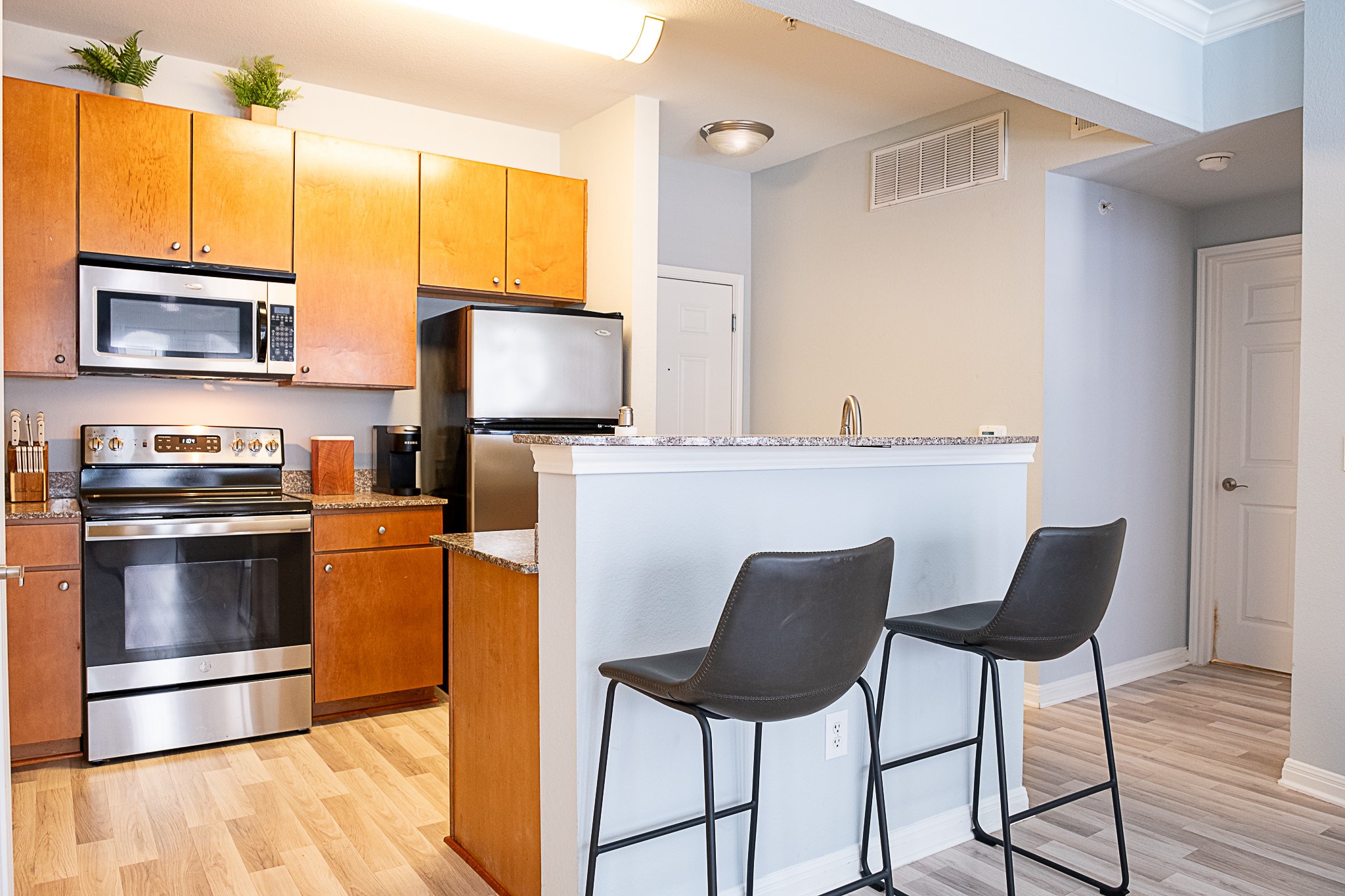 2502 Leon Street, Unit 309 Austin, TX 78705 - Photo 2 of 19 a kitchen with stainless steel appliances a stove a refrigerator and a microwave