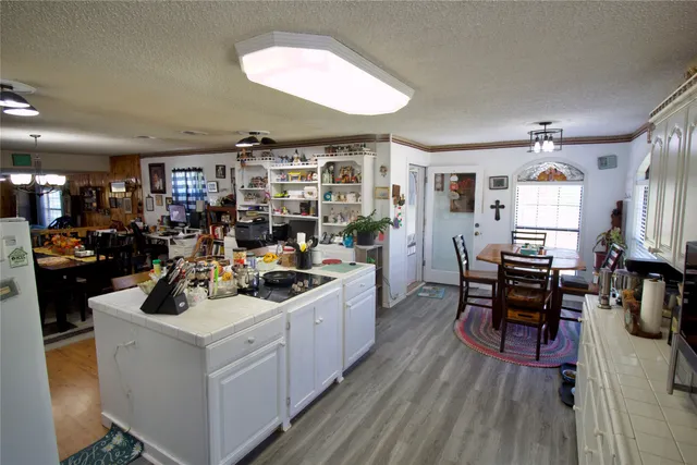 a bedroom with a bed and dresser with mirror
