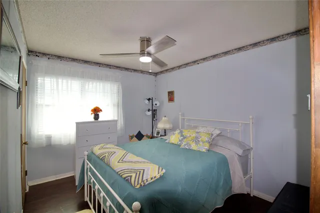 a view of a house with a small yard and sitting area