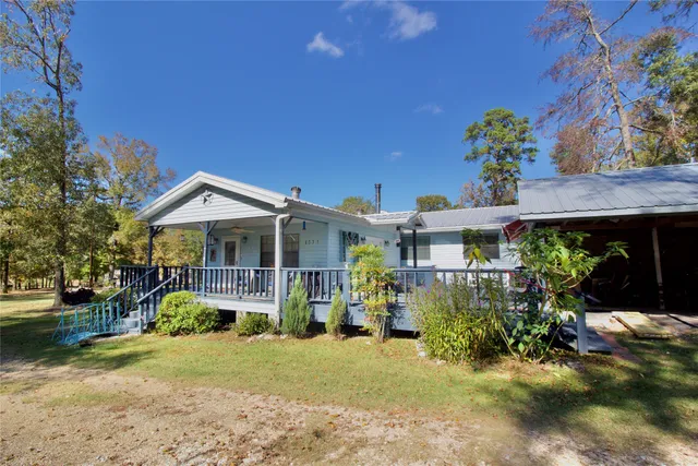 a view of a house with a yard and sitting area