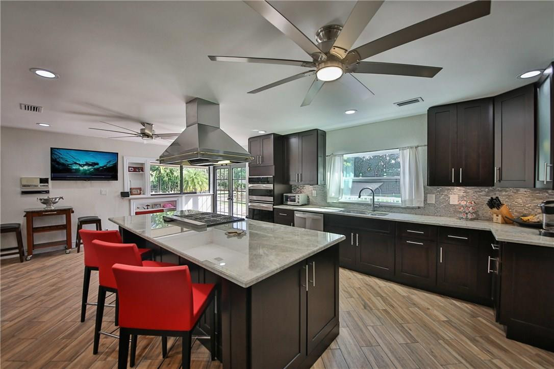 17901 Southwest 68th Court Southwest Ranches, FL 33331 - Photo 8 of 34 a kitchen with stainless steel appliances granite countertop a sink a stove counter space and dining table