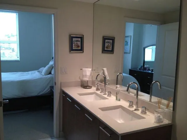 a bathroom with double sink and a mirror