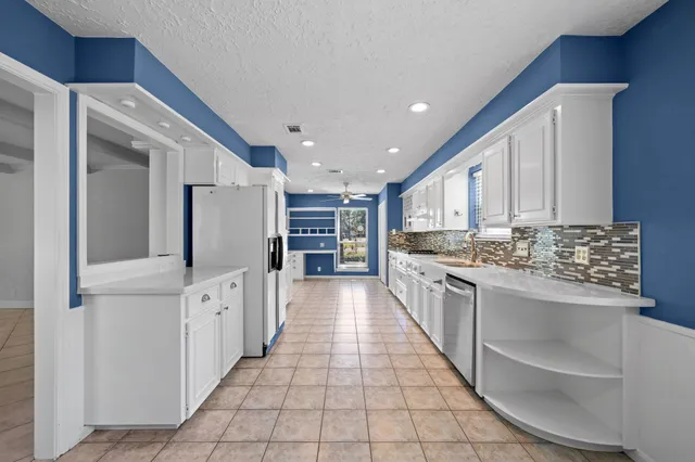 a large kitchen with stainless steel appliances lots of counter space and cabinets