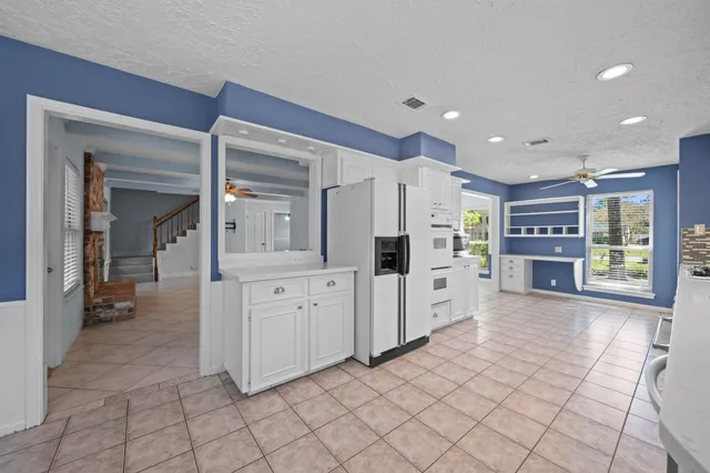 a large white kitchen with a stove a sink and dishwasher