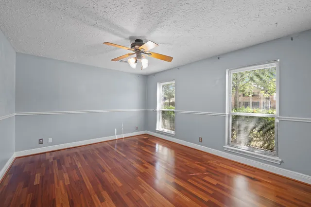 wooden floor in an empty room with a window